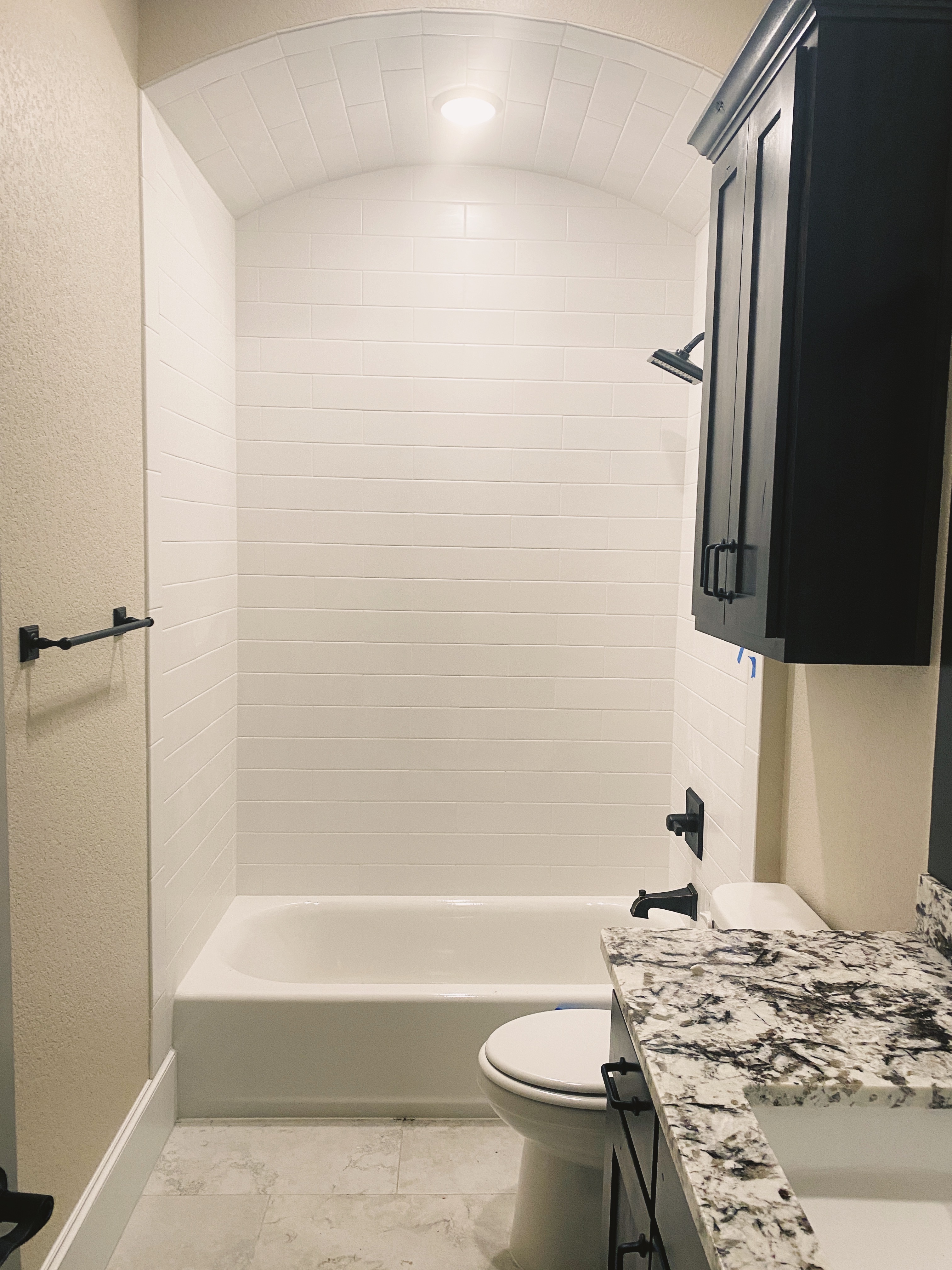 Master bathroom countertop with white marble-look quartz and decorative geometric floor tile