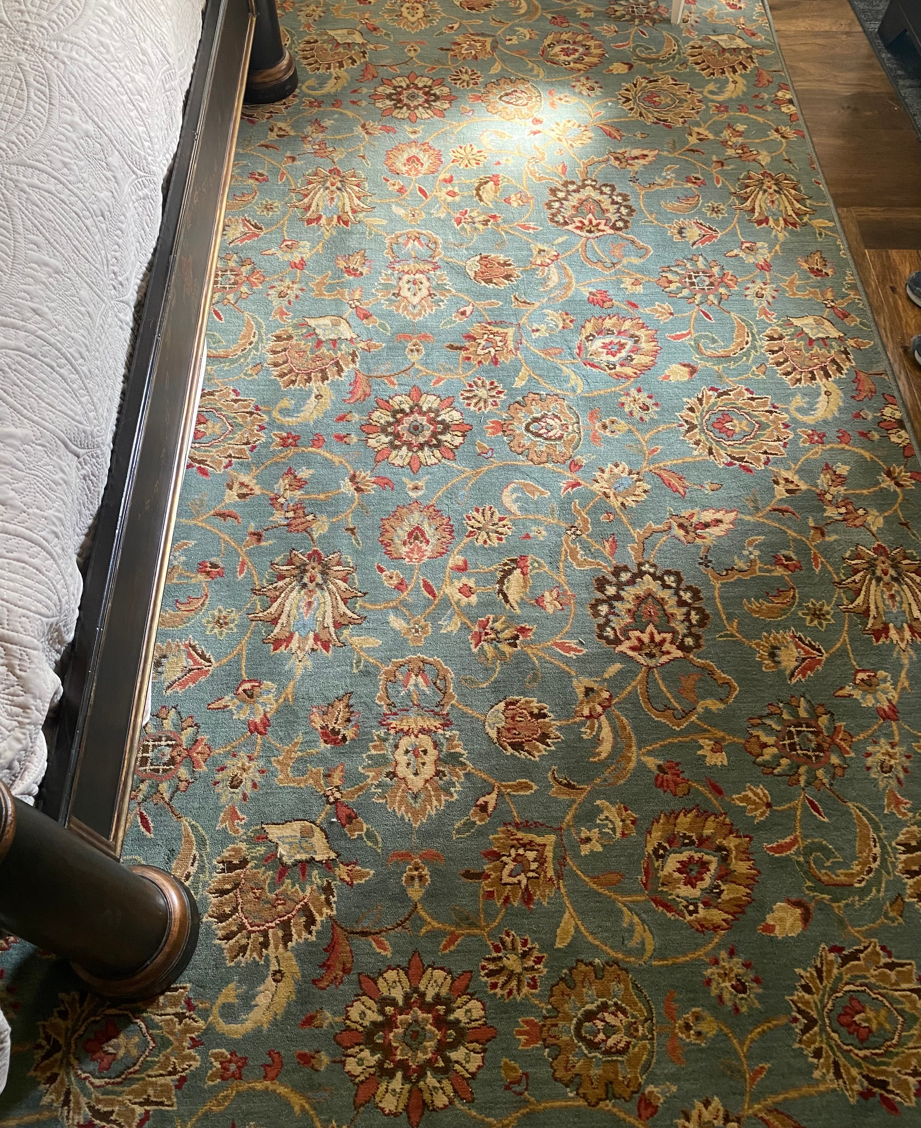 Traditional Persian-style area rug with turquoise base and ornate floral gold pattern