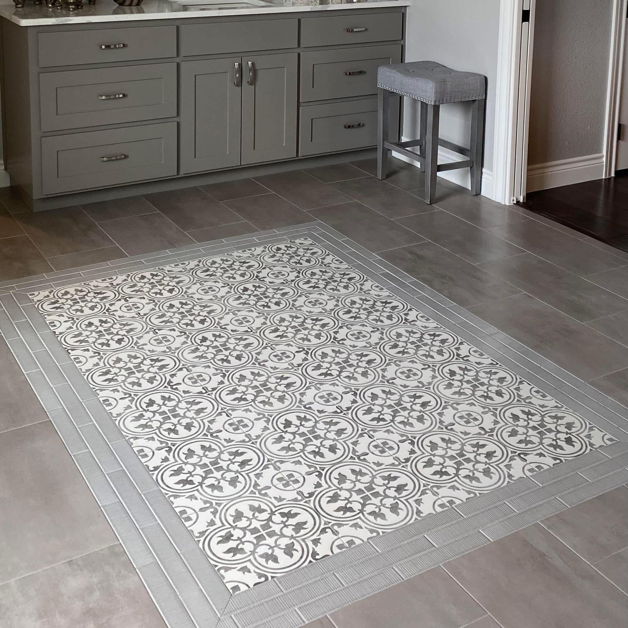 Decorative mosaic tile floor inlay with grey porcelain tile surround in Wise County kitchen
