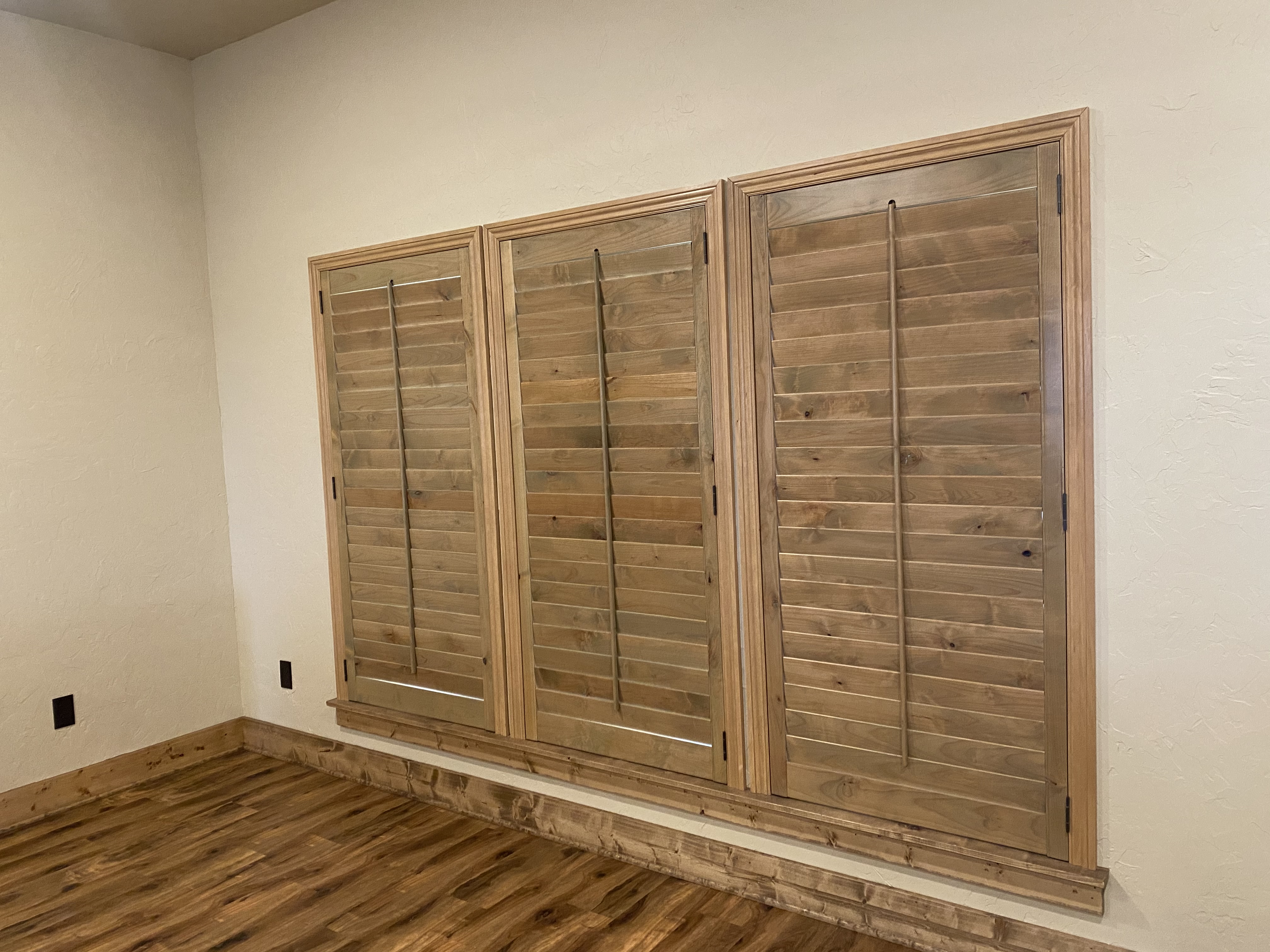 Natural wood plantation shutters installation in Wise County bedroom