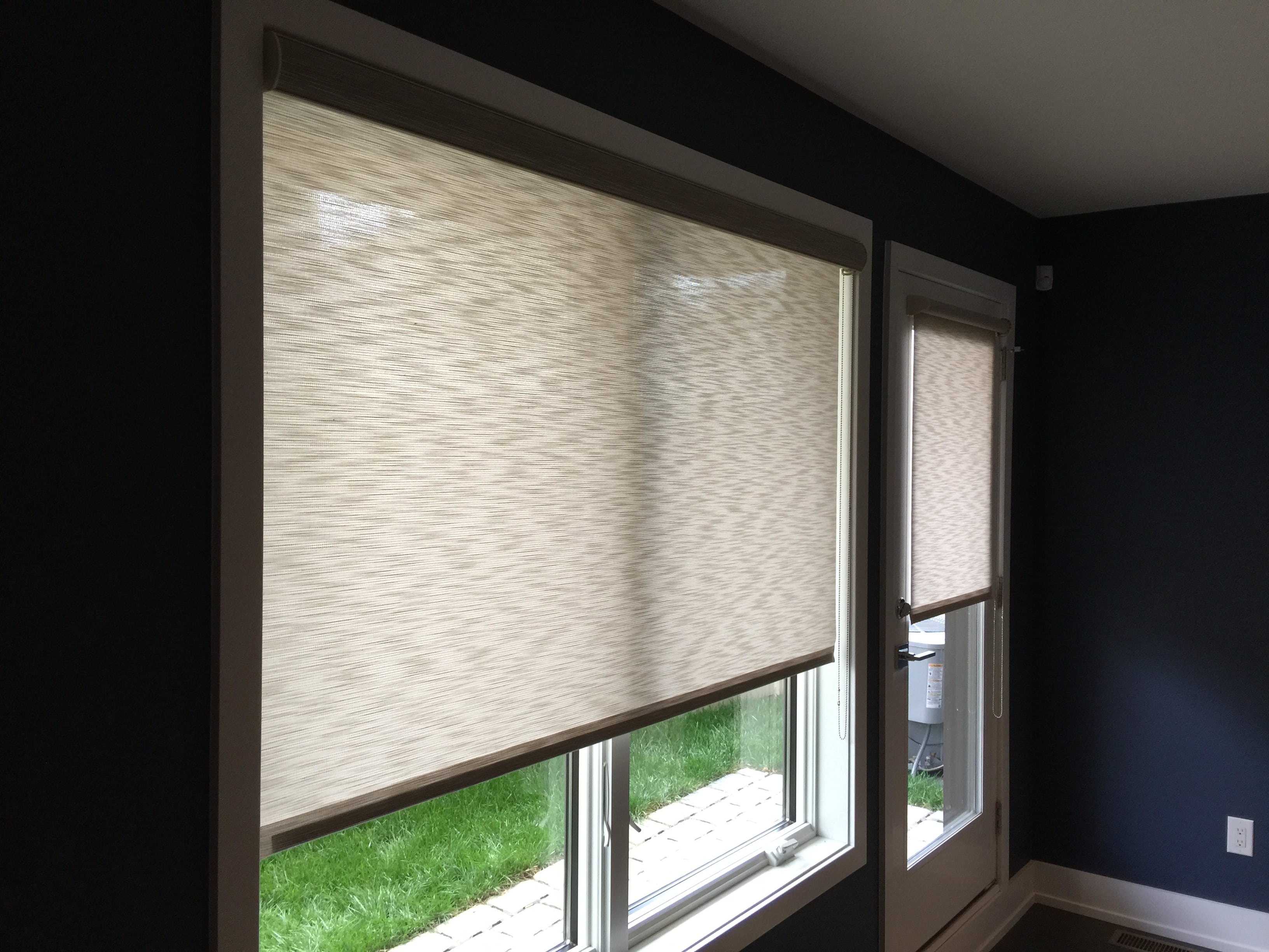 Custom roman shades and door panel shade installation in Wise County living room